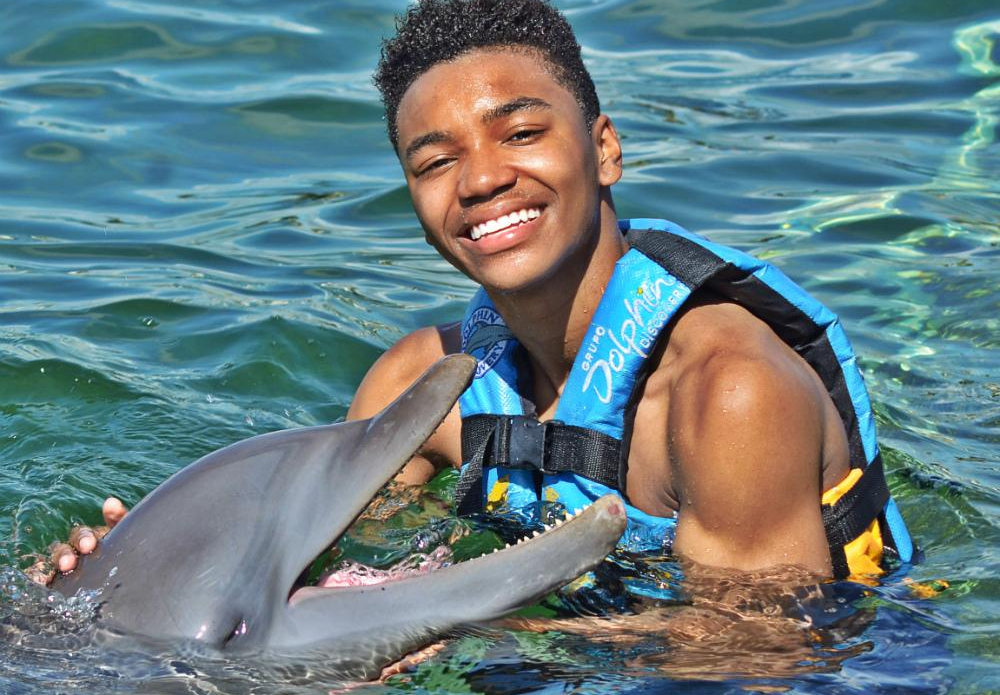 Teenager With Dolphin at Cancun, Mexico’s Dolphin Discovery fun park
